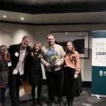 Myno’s Lauren Breynaert and Thor Kallestad receiving the award from Commissioner of Public Lands Hilary Franz, Dan Giuliani, and Regan Spencer.