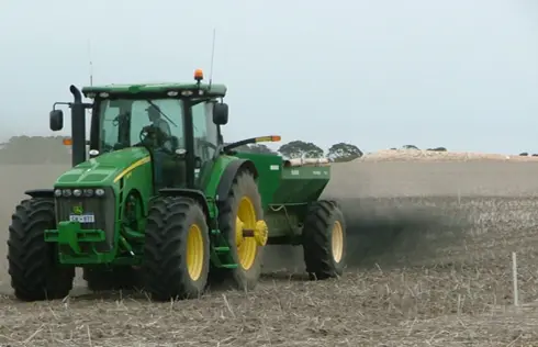 Farmer applying biochar product on to an agricultural field