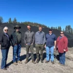 Staff from Myno Carbon, Stevens County Conservation District, and WSU Extension in front of biochar product in Kettle Falls, Washington